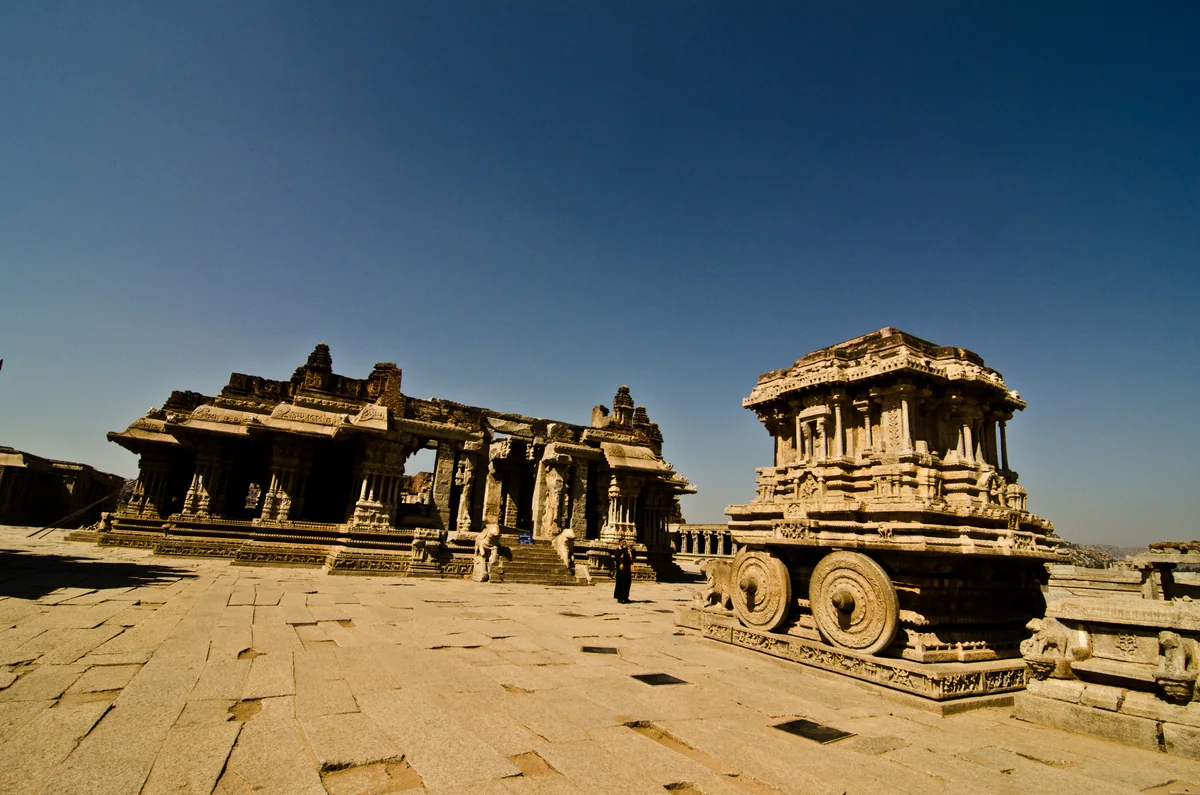 Virupaksha Temple tower and the traditional wooden chariot in Hampi
